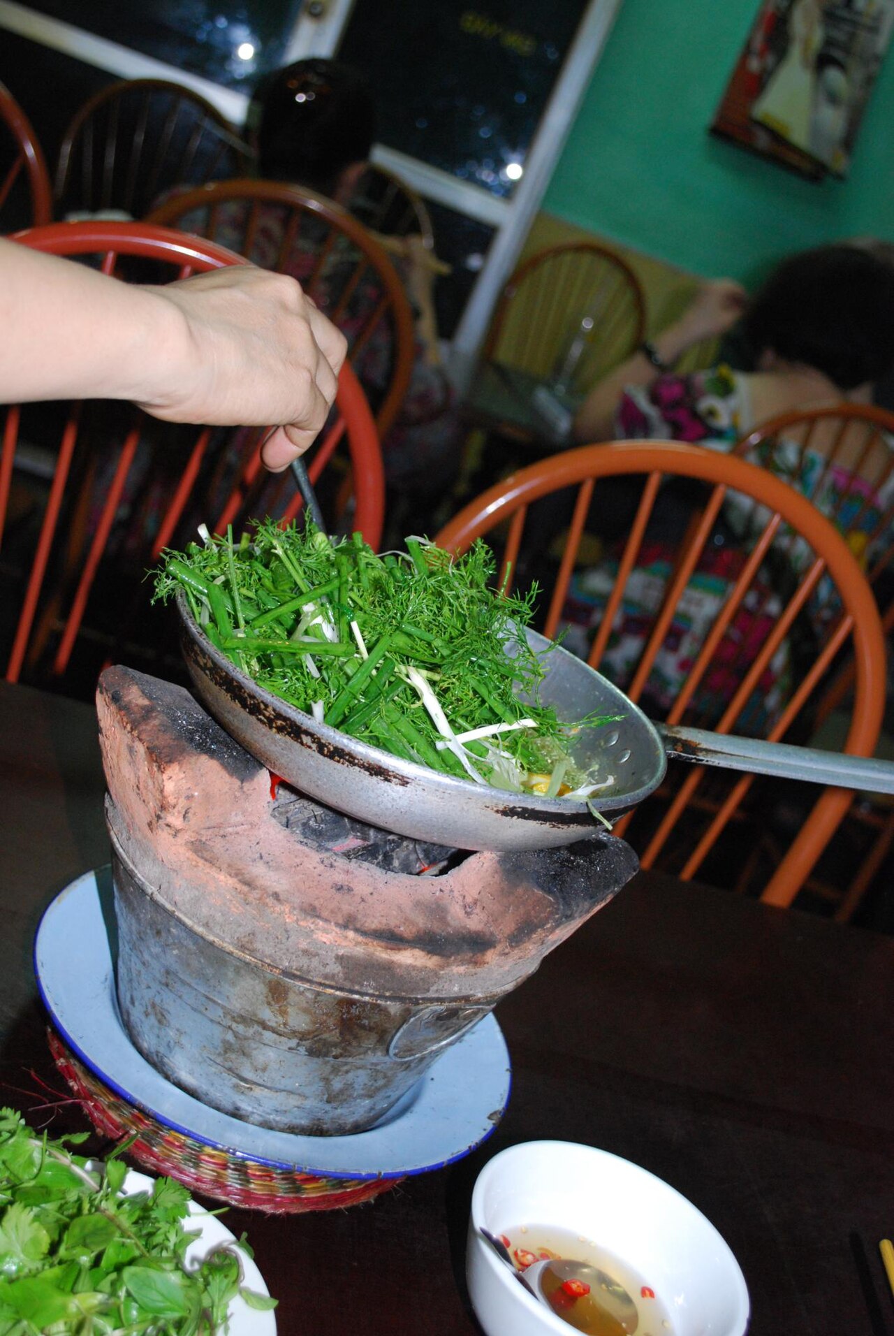 Waitress adding dill - Cha Ca La Vong