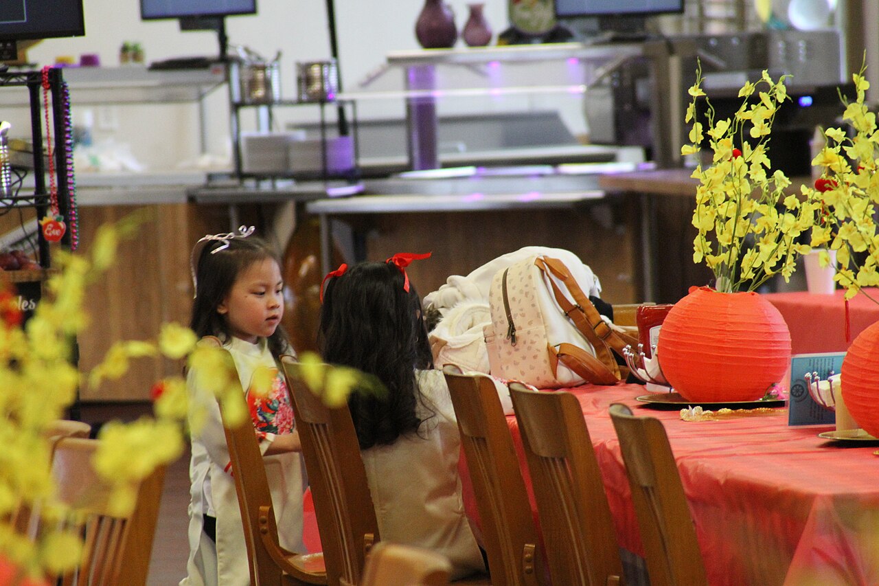 St. Ben TET celebration - 2024- little princesses play while their mothers prepare the meal for the celebration